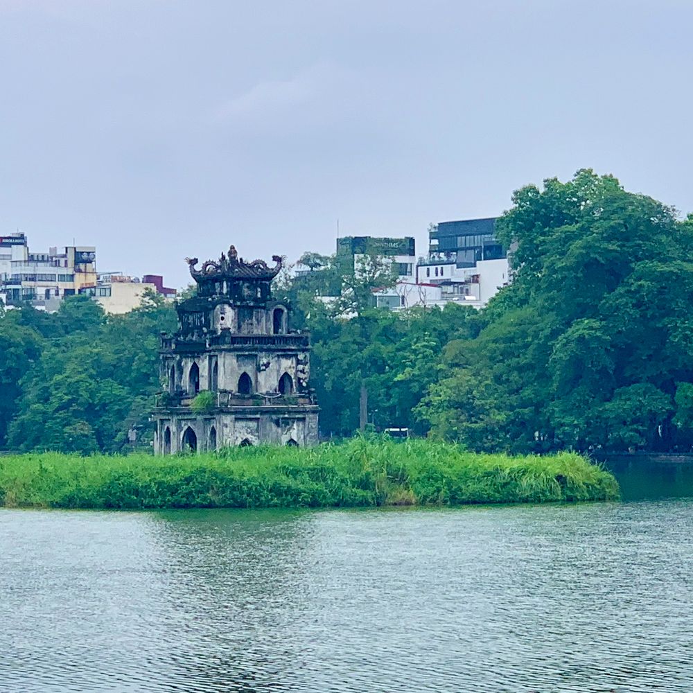 Turtle Tower on Hoan Kiem Lake surrounded by greenery in central Hanoi