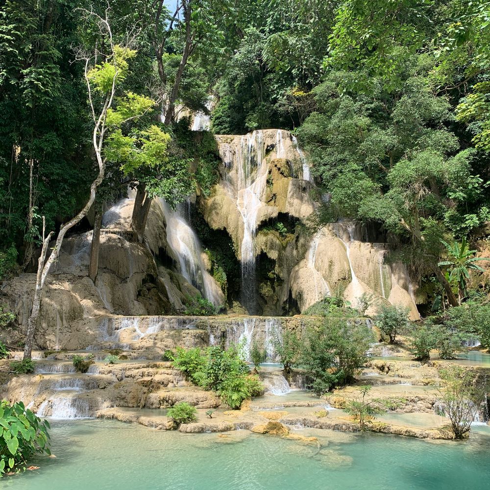 Turquoise cascades of the Kuang Si waterfalls amid lush jungle