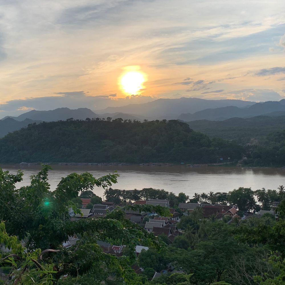 Sunset over the Mekong River and forested hills near Luang Prabang