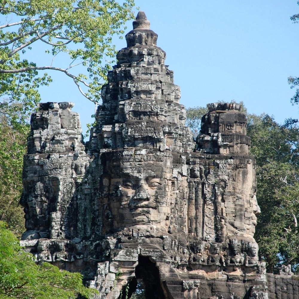 Carved stone faces of the Bayon temple gateway at Angkor Thom