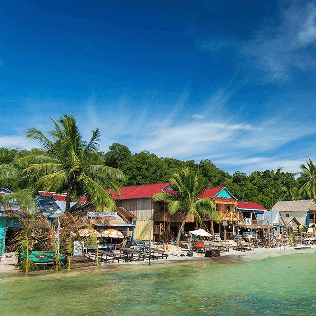 Palm-lined beach and stilt houses on a tropical Cambodian island