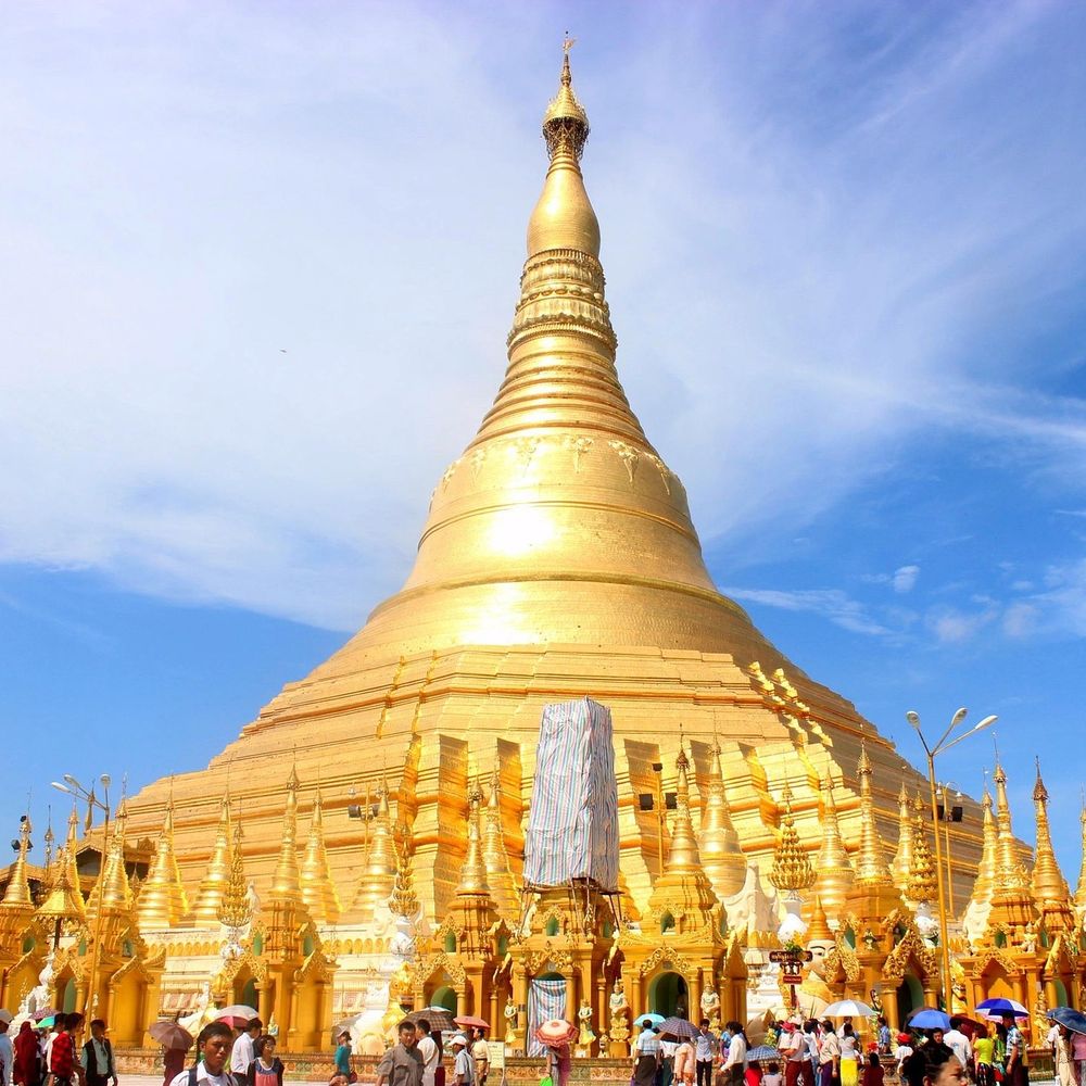The golden Shwedagon Pagoda gleaming against a blue sky in Yangon