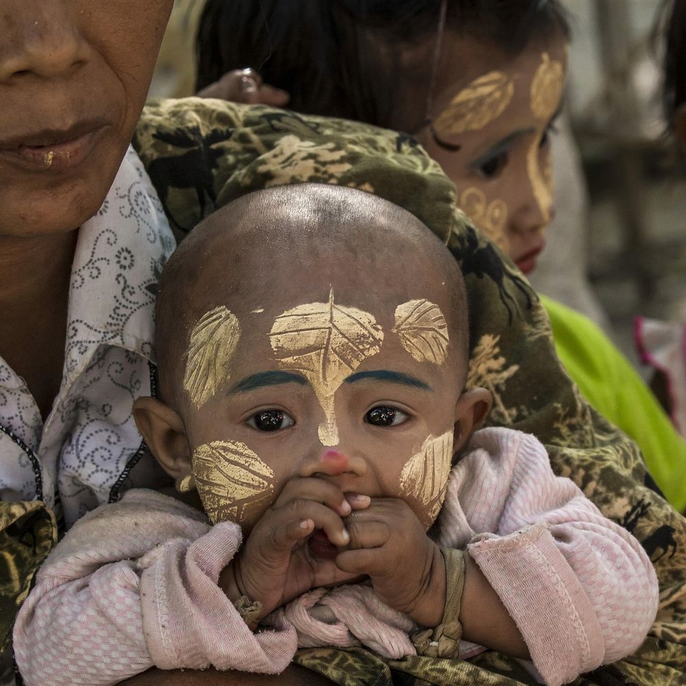 Mother and child with traditional thanaka face paint