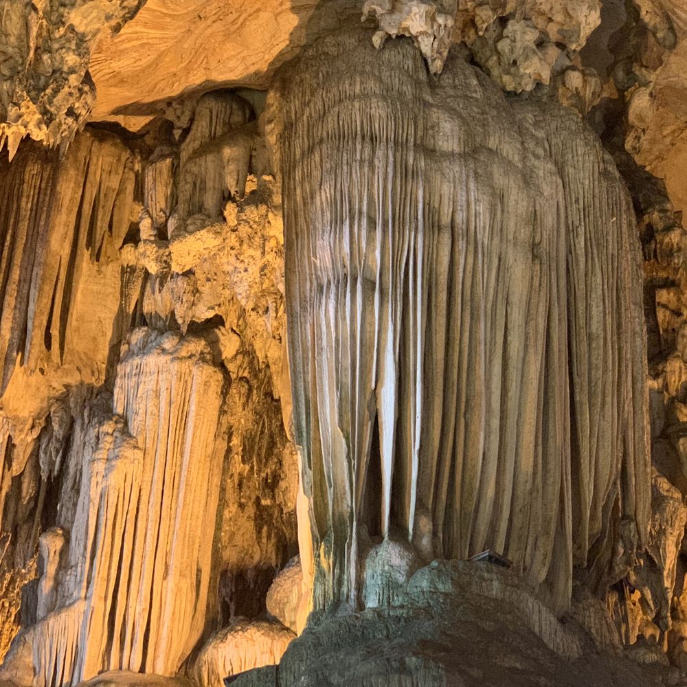 Dramatic stalactite formations inside a limestone cave