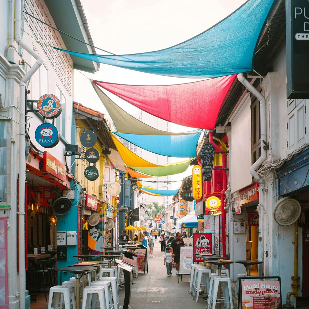Colourful sail canopies shading a lively street in Kampong Glam