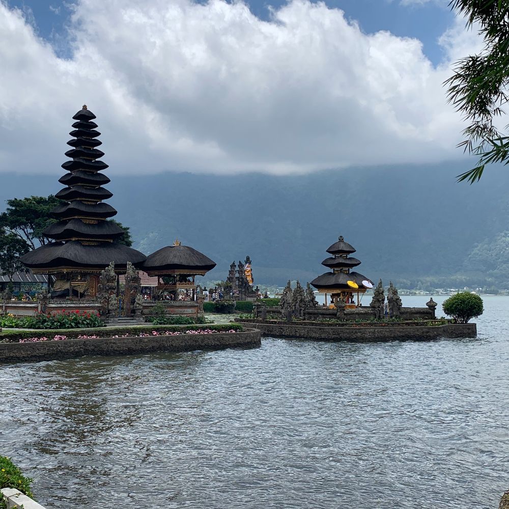 Pura Ulun Danu Bratan water temple on the lake beneath cloudy mountains, Bali