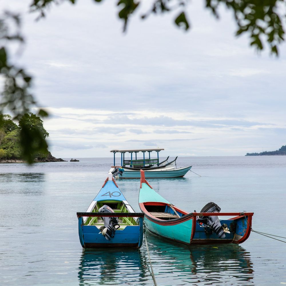 Traditional wooden bangka boats moored in calm coastal waters near Palawan