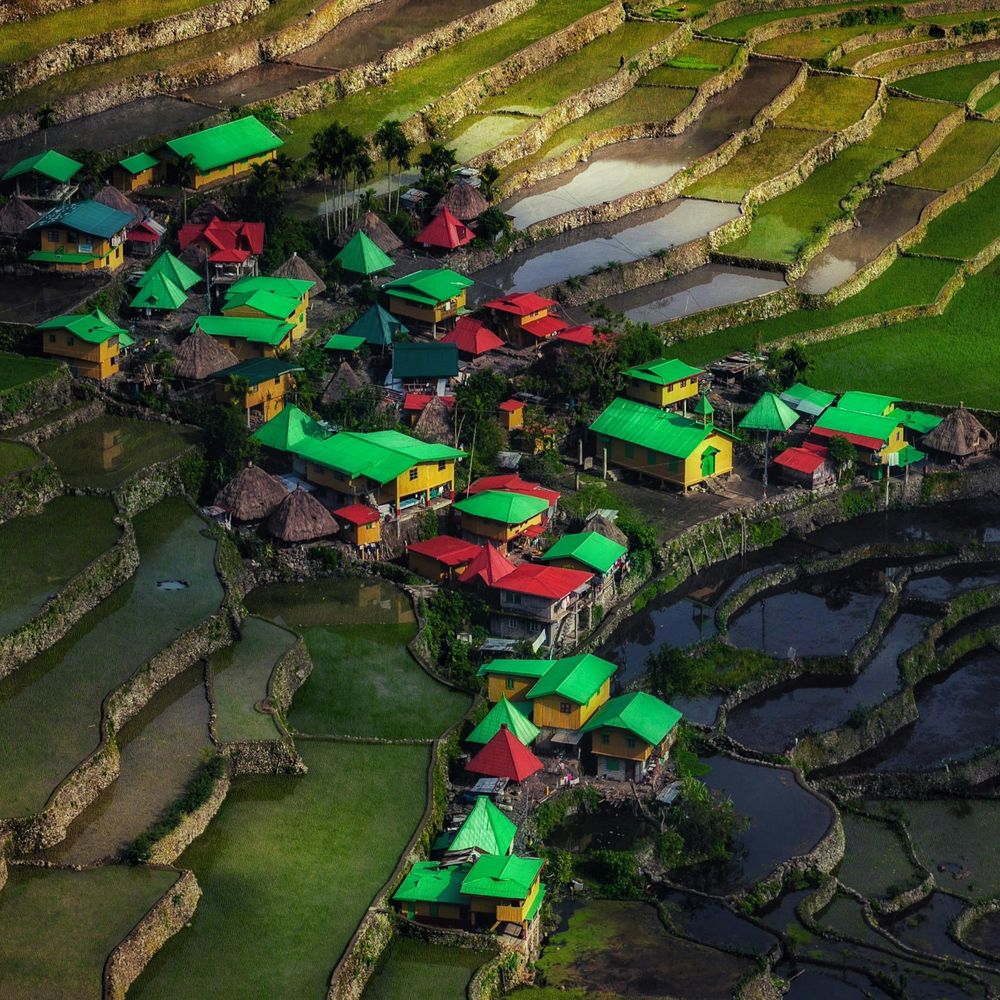 Aerial view of a mountain village among the green rice terraces of the Cordillera