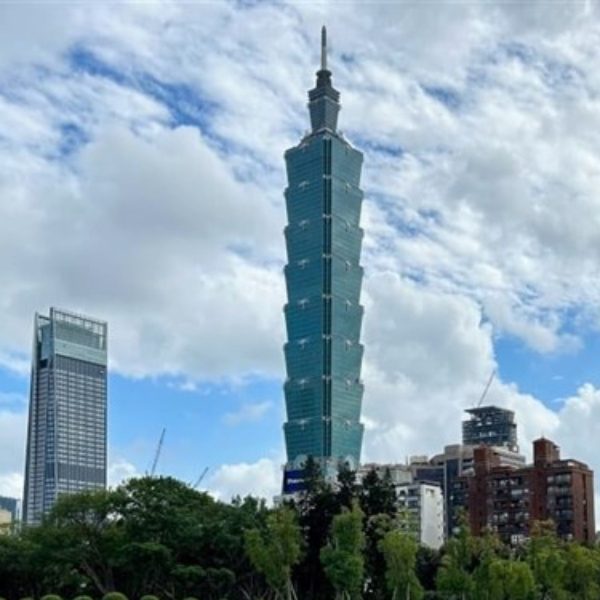Taipei 101 skyscraper towering above the city skyline under a cloudy sky