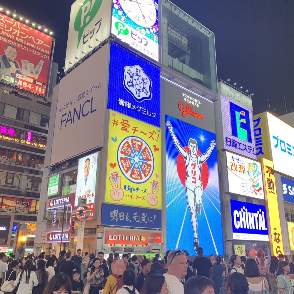 Bright neon billboards and crowds in the Dotonbori district of Osaka
